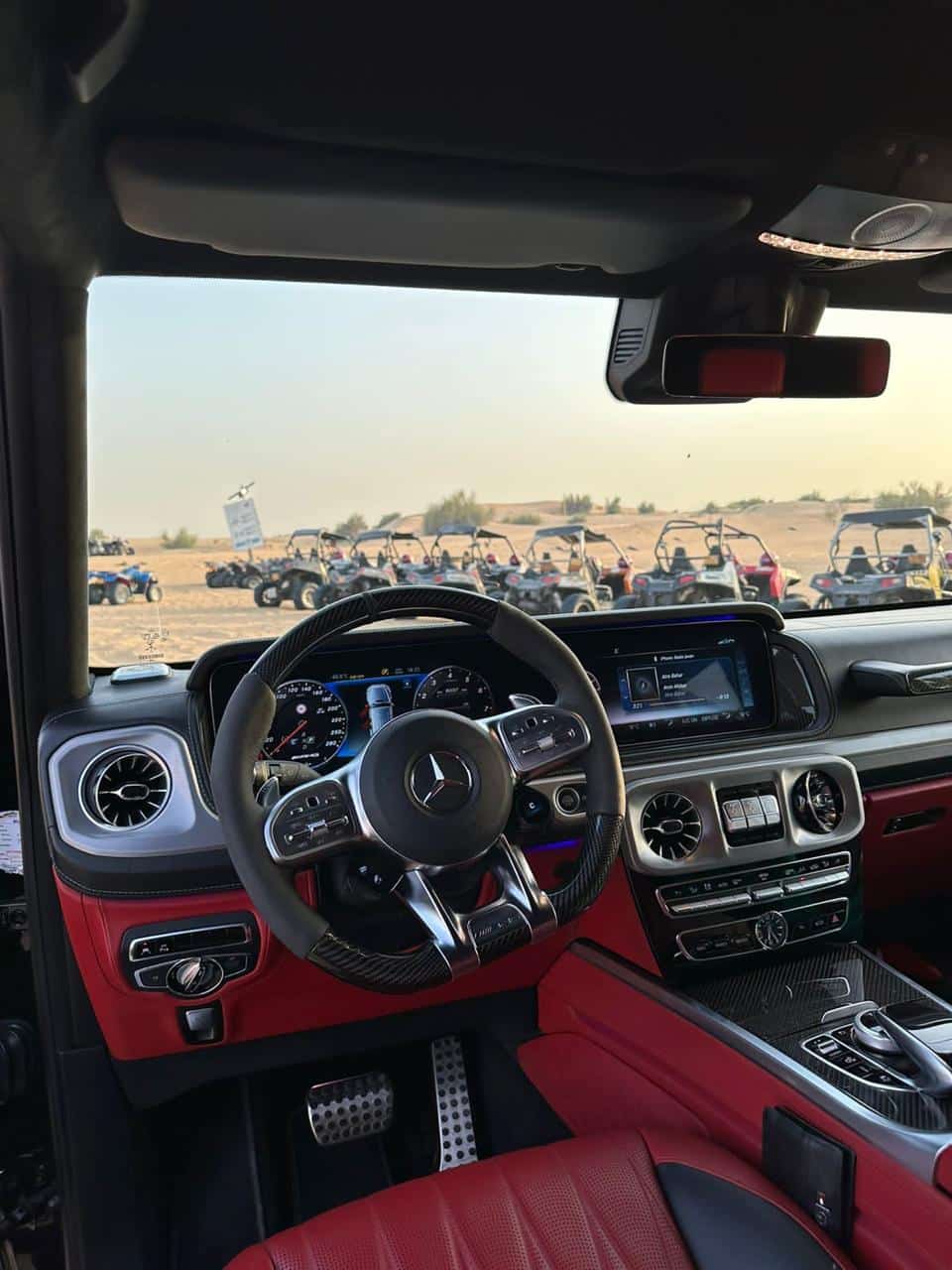 Luxury Mercedes G-Class driving through Dubai desert dunes on a VIP G-Class Desert Safari Dubai
