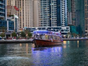 Traditional dhow sunset cruise Dubai marina boat sailing through Dubai Marina at sunset with skyline views