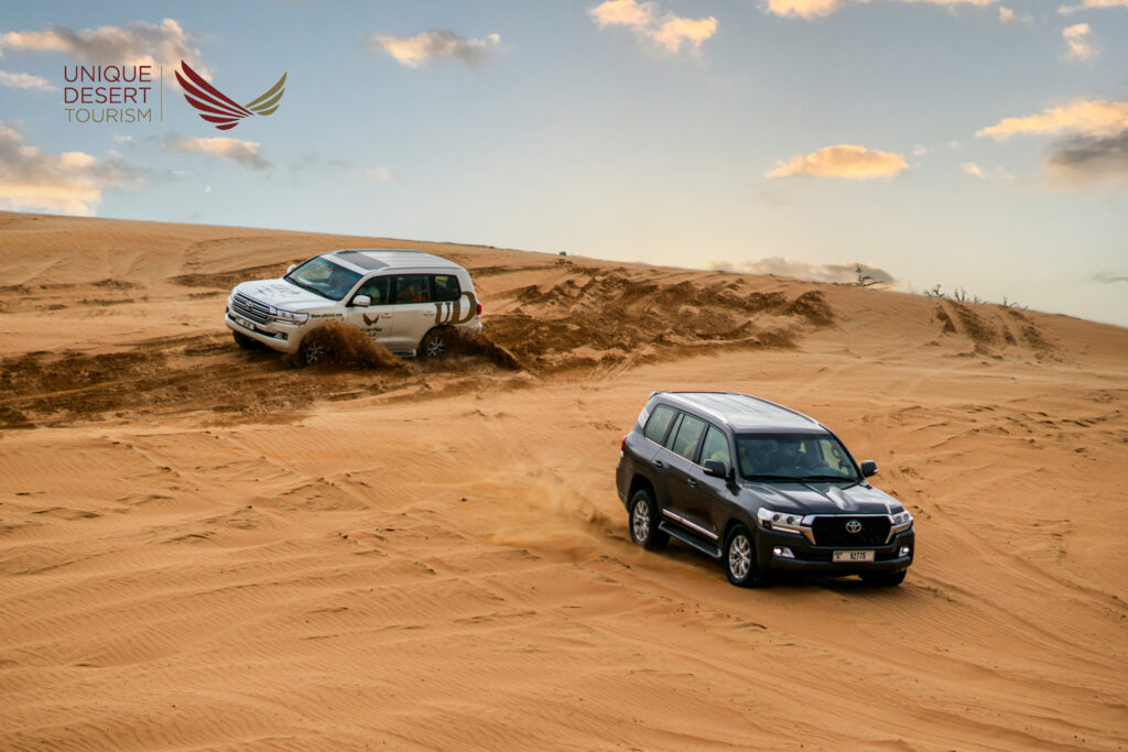 Tourists enjoying a thrilling Desert Safari Dubai with dune bashing, camel ride, and sunset views.